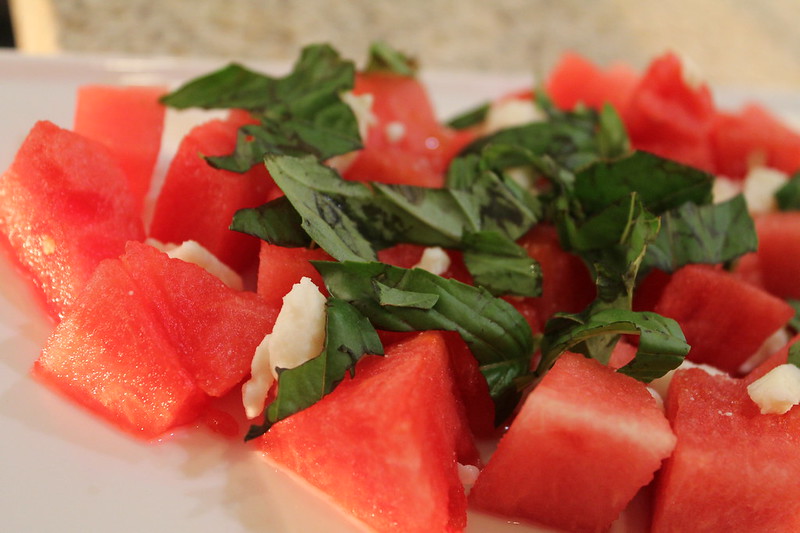 cut watermelon, with crumbled feta and chopped basil